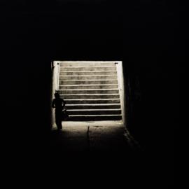 Schoolboy entering dark tunnel